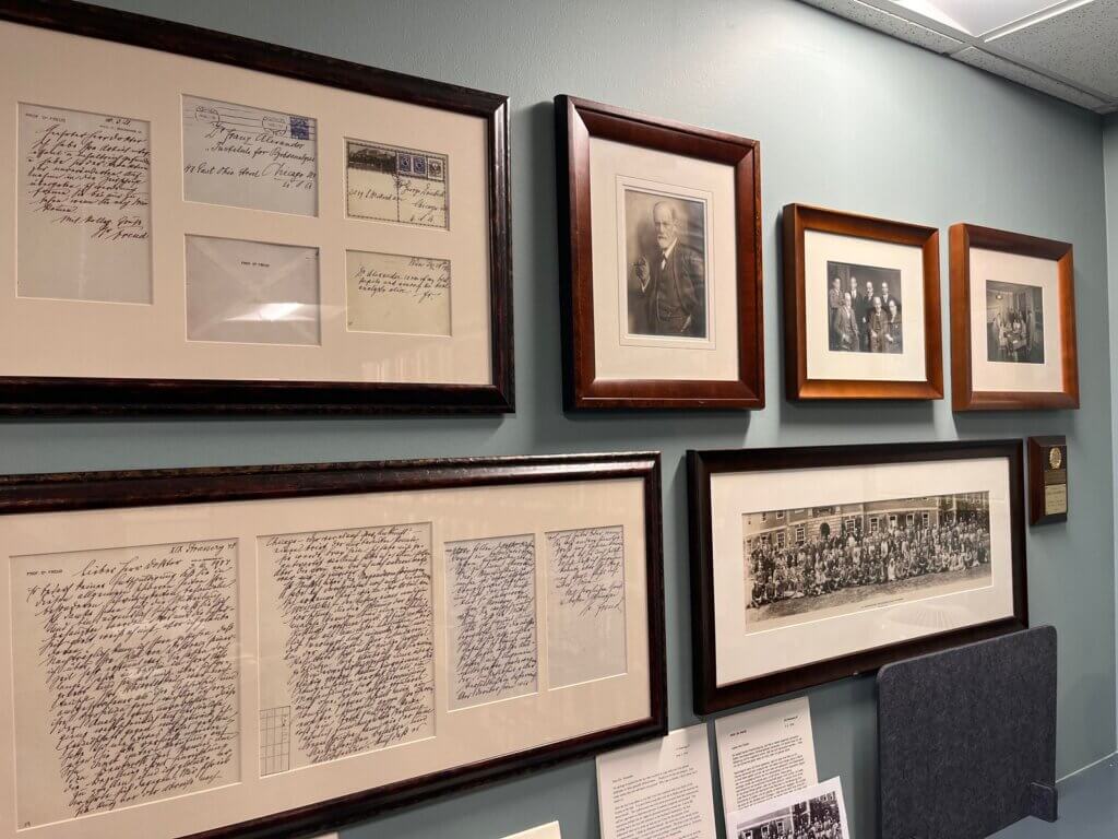 Framed historical documents and photographs.