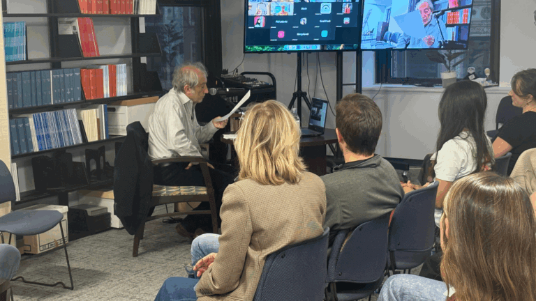 Group meeting with virtual participants displayed.